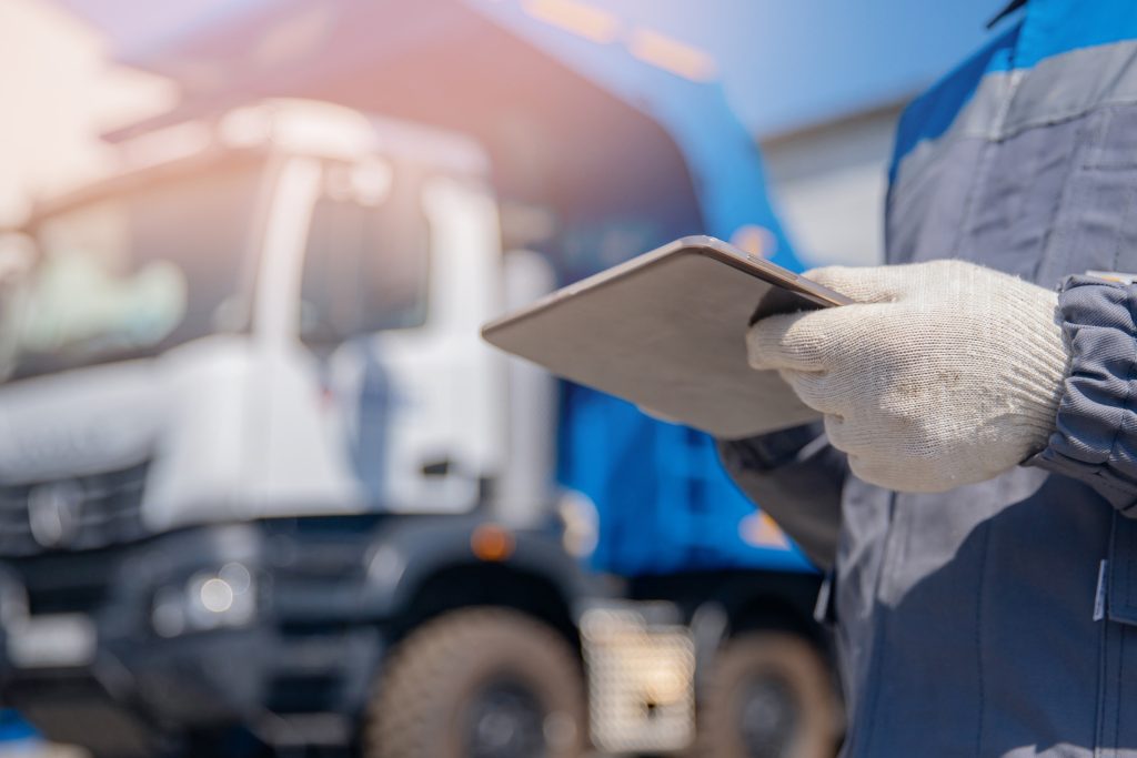 A worker from a junk removal service company checks the work order to ensure they've picked up all items. 