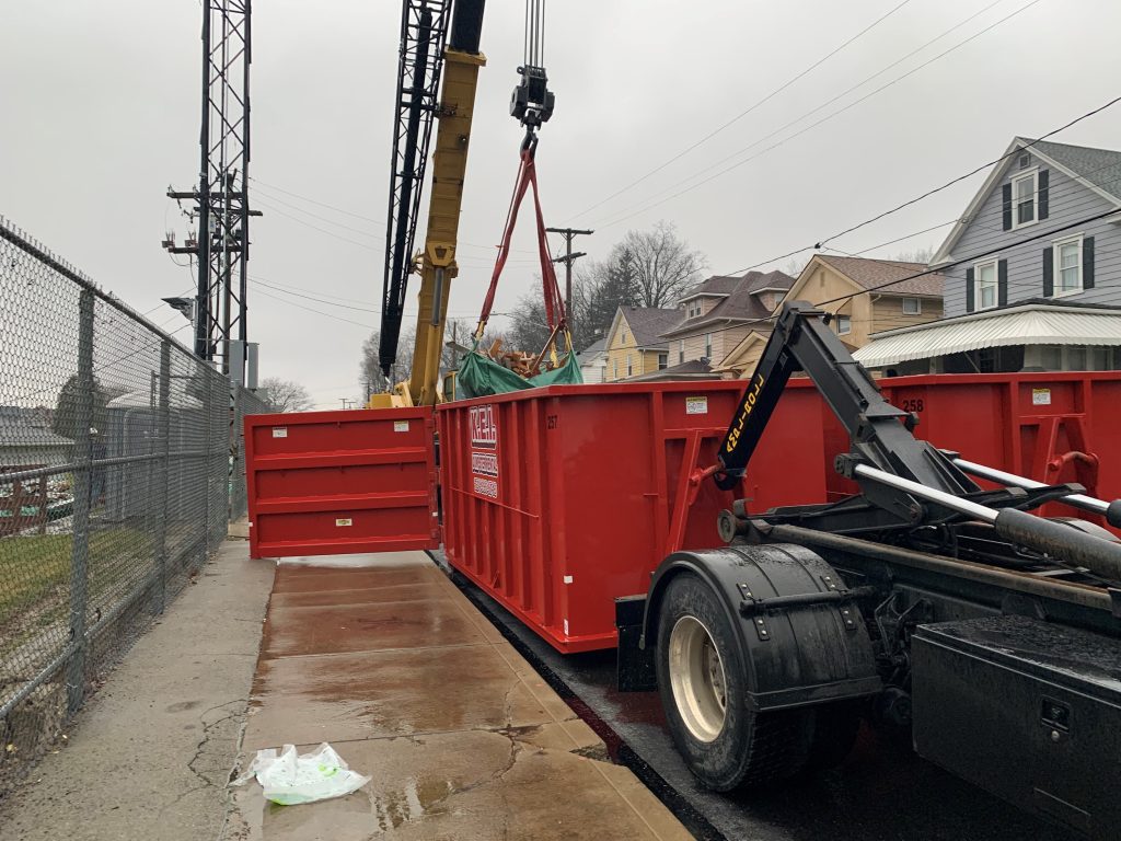 A KEI delivery truck drops off different dumpster sizes for a construction site in Butler County. 