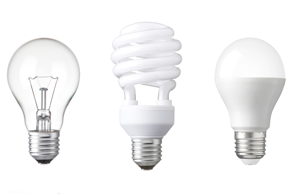 Three different kinds of lightbulbs are lined up next to one other. 