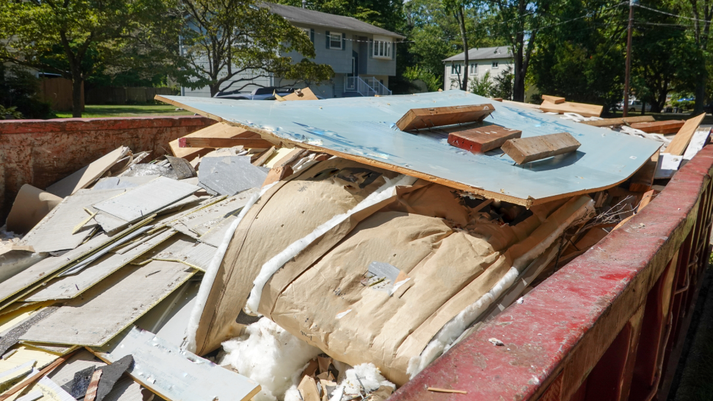 Local dumpster rentals are specific to the type and amount of debris you plan to dispose of. This construction dumpster is full of drywall, boards with nails, and insulation. 
