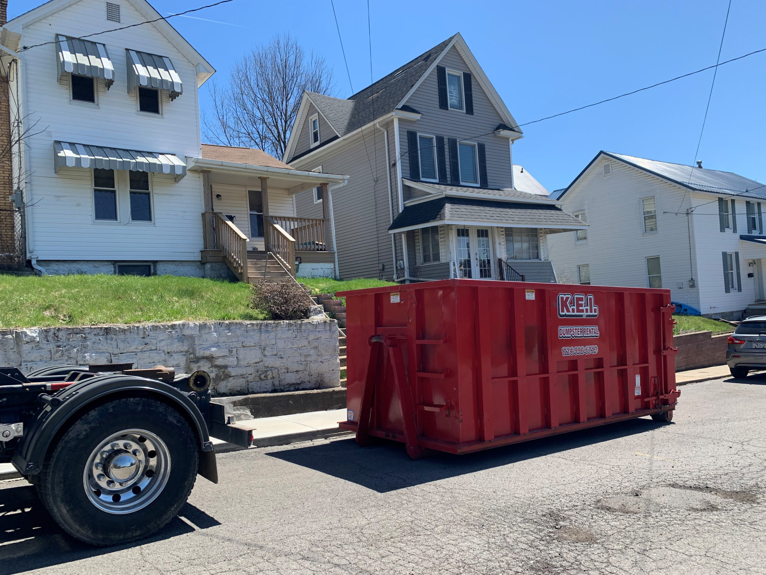 A KEI dumpster rental sits in the street in Butler.
